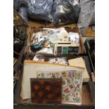 Two trays containing an assortment of cigarette cards, match boxes, stamps etc.