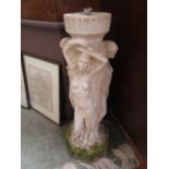 A weathered stoneware garden base in the form of maidens