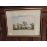 A framed and glazed watercolour of country scene with church in foreground signed John Killingback