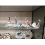 A set of four Lladro figures of seated ballerinas