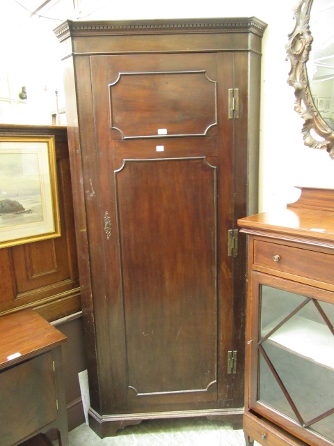 An 18th century and later mahogany floor standing corner cupboard, h. 198 cm, w.