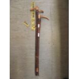 A selection of walking canes and riding crops to include antler handled examples,