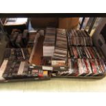 Four trays containing DVDs together with a tray of CDs