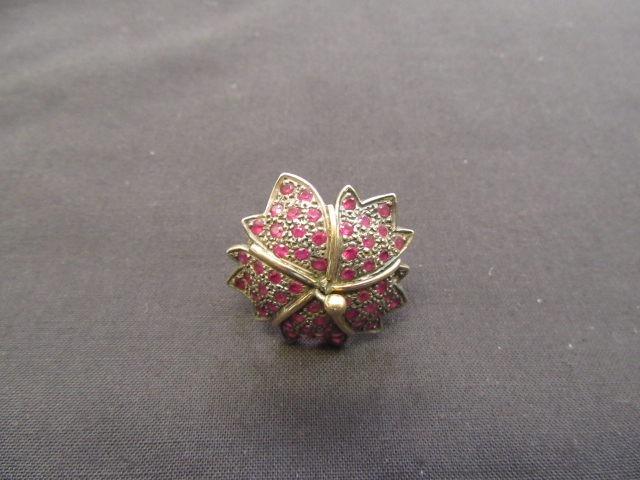 A yellow and white metal, ruby and diamond cluster ring marked '18k silver'. The approximately 2.