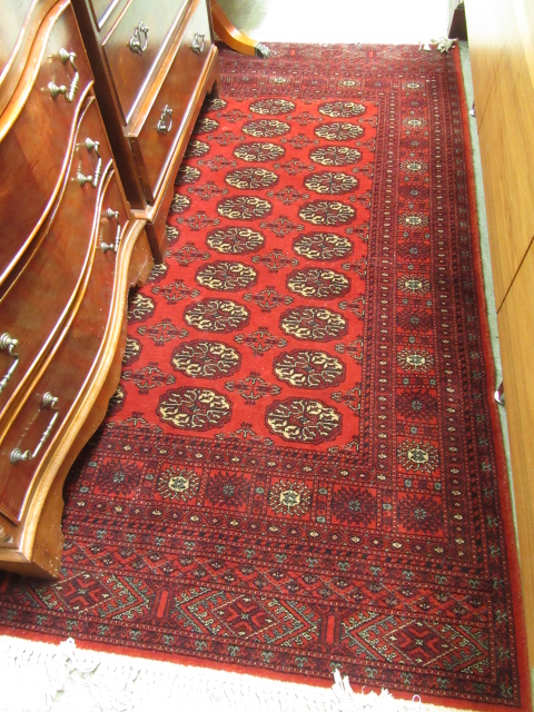 A rectangular red ground rug