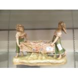 A Royal Dux figural group of two children with basket CONDITION REPORT: Several