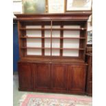 A Victorian and later mahogany bookcase having open storage above four cupboard doors