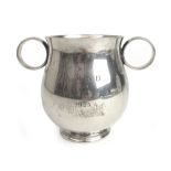 A George V silver presentation porringer of bulbous form.