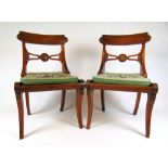 A pair of early 19th century rosewood and brass mounted chairs,