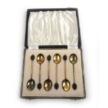 A set of six silver gilt and enamel coffee bean spoons.