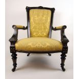 A late Victorian ebonized and parcel gilt open arm salon chair upholstered in a floral yellow