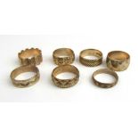 A collection of seven 9ct gold engraved band rings. Approx weight 25.