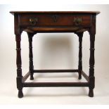 An early 18th century and later oak single drawer side table, on turned legs united by stretchers,