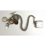 A substantial silver single Albert chain together with a selection of fobs and a vesta case.