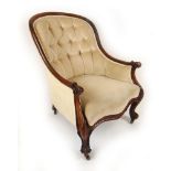 A Victorian walnut armchair upholstered in a beige button back cut fabric,