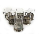 A set of six white metal glass holders with glasses. Stamped '84'.