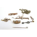 An assortment of 9ct gold and yellow metal items to include opal brooches, cravat ring,