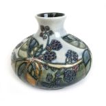 A squat Moorcroft vase, decorated in a bramble and blackberry pattern on a grey/green ground, h.