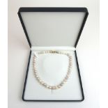 A single strand cultured pearl necklace having a 14ct gold clasp, l.