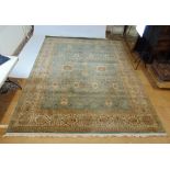 A handwoven Persian rug, the triple line border enclosing a blue ground field with floral motif's,