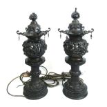 A pair of early 20th century Japanese bronze lanterns of pagoda form with pierced and relief cast