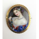 A late 19th century yellow metal painted porcelain brooch depicting a young lady, l. 5.3 cm.
