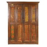 An early 20th century pine four door housekeepers cupboard with applied stamp decoration to the