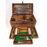 An early 20th century pine tool chest containing a selection of hand tools to include saws, chisels,