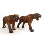 A pair of mid 20th century possibly Japanese polychrome leather models of tigers, h. 36 cm, l.