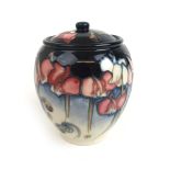 A Moorcroft 'Wild Cyclamen' pot and cover decorated on a blue and white ground, h.