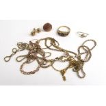 An assortment of 9ct gold and yellow metal items to include chains, garnet ring, knot earrings etc.