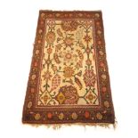 A handwoven Turkish rug, the main floral border surrounding a cream ground field with floral motifs,