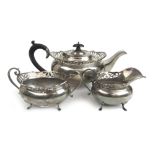 A George VI silver three piece tea set having pierced decoration to rims.