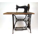 A Singer leather sewing machine, model number '45 K 1' on treadle base, h.