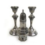 A pair of Elizabeth II silver candlesticks together with an Elizabeth II silver sugar caster.