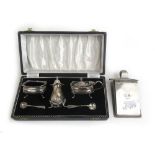 An Elizabeth II cased silver three piece cruet set together with a George V silver fronted desk