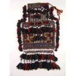 A hand woven Eastern salt bag with beaded tassel decoration, h.