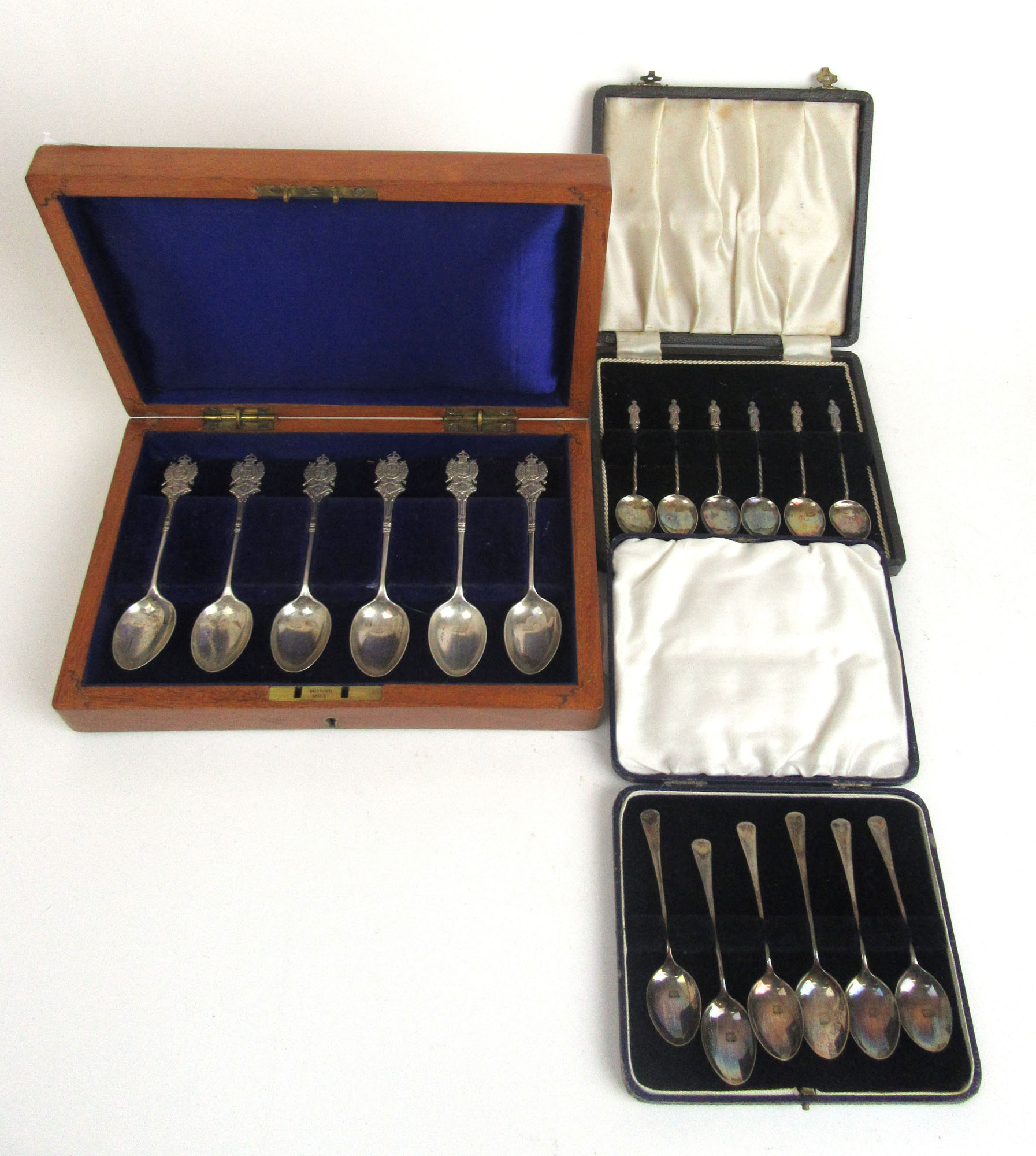 A cased set of London Rifle Brigade silver spoons together with a cased set of silver apostle