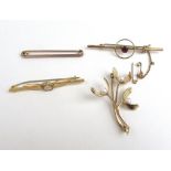 A collection of four 9ct gold and yellow metal brooches to include a branch design brooch.