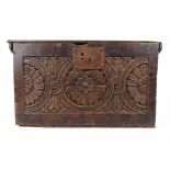 A late 17th century oak box, the top over the floral guilloche carved front, h. 29 cm, w. 52 cm, d.