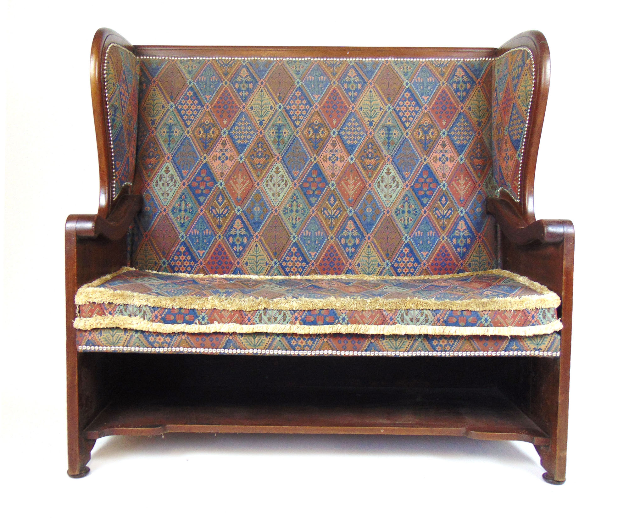 A late 19th century walnut settle with floral carved sides upholstered in a patterned fabric, h.