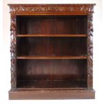 A Victorian carved oak open bookcase,