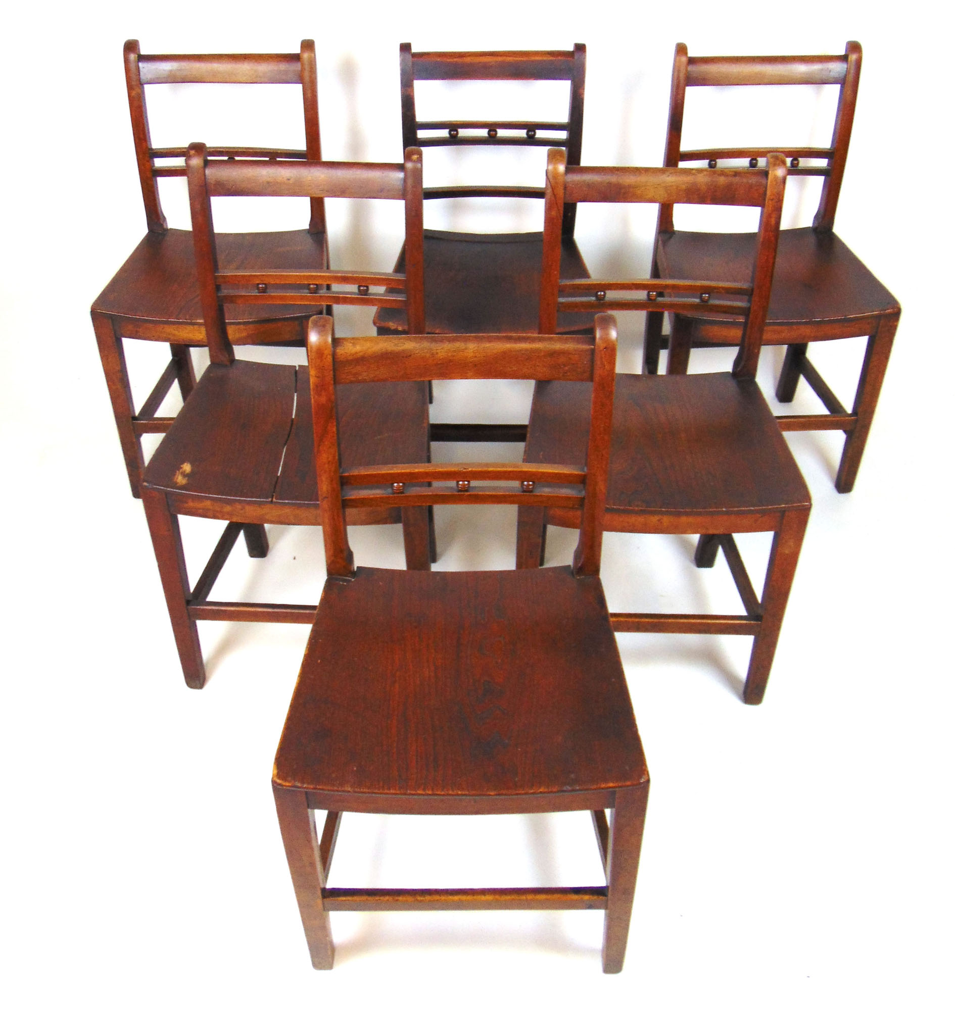 A set of five early 19th century elm and walnut dining chairs,