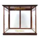 An early 20th century and later Cadbury's chocolates shop display cabinet with later glazed sliding