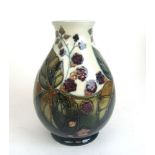 A Moorcroft ovoid vase decorated in a bramble and blackberry pattern on a grey/green ground, h.