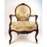 A 19th century rosewood and inlaid open arm chair upholstered in a floral fabric, h. 99 cm, w.