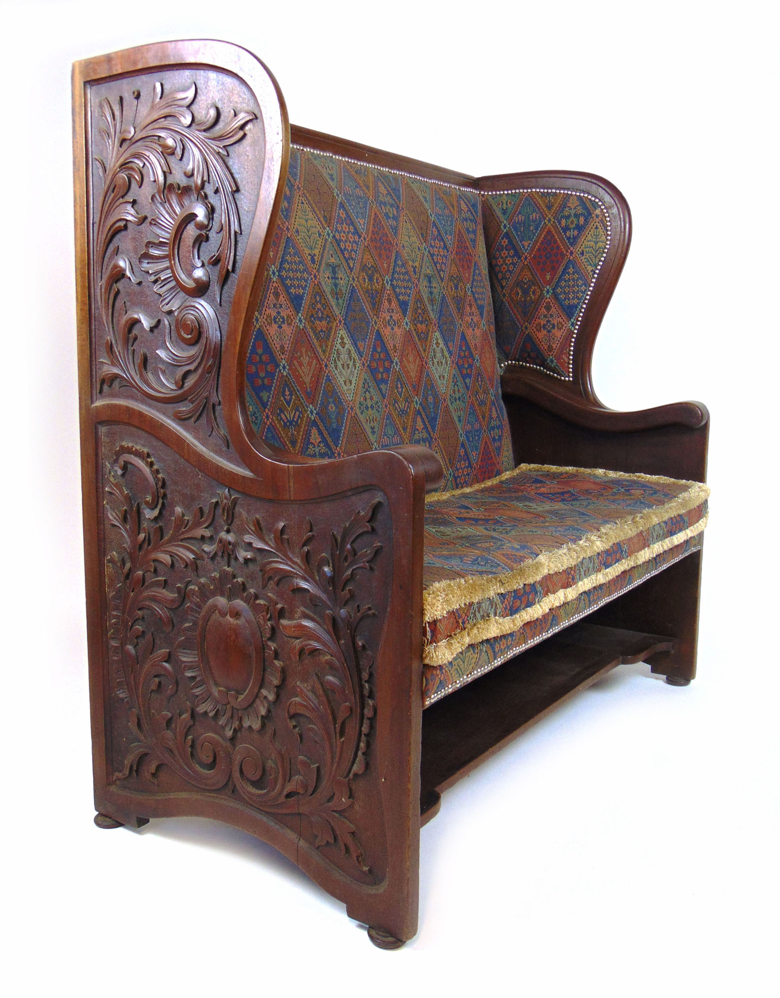 A late 19th century walnut settle with floral carved sides upholstered in a patterned fabric, h. - Image 2 of 3