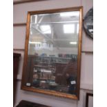 A gilt framed bevel glass rectangular wall mirror