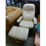 A stressless reclining armchair with matching stool in cream leather