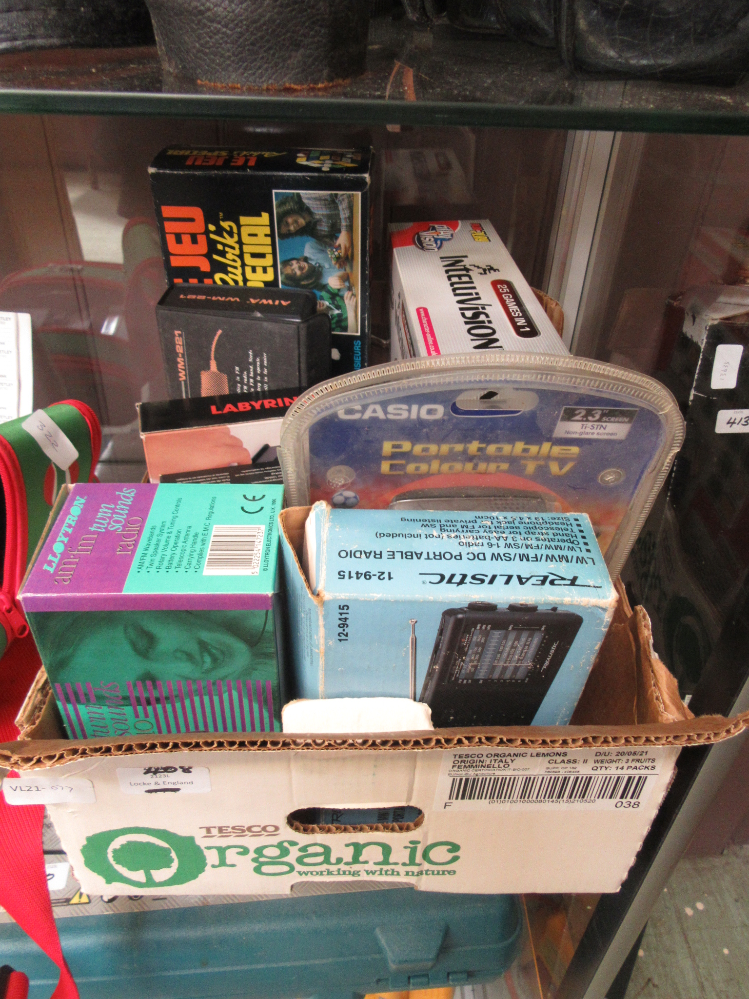 A box of assorted electrical items to include a portable television, radios games etc.